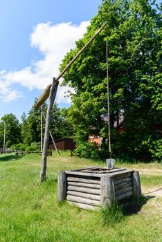 picturesque rural landscape with a well a crane.