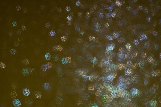 Christmas background. Festive abstract background with bokeh defocused lights and stars.