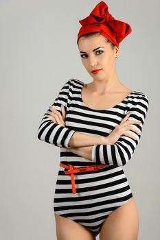 Studio portrait of a beautiful woman in sailor stripes swimsuit