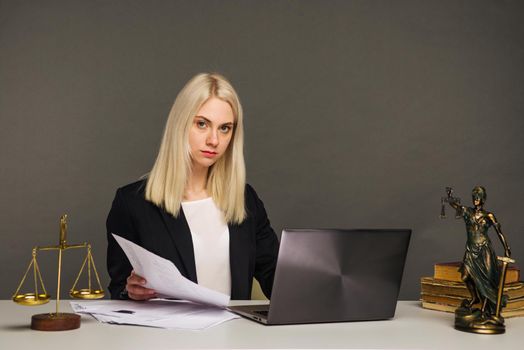 Portrait of smiling businesswoman looking at camera while working at office - image