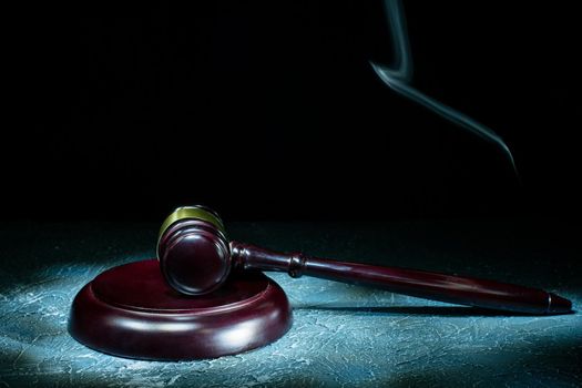 Judge's gavel lies on a stone table. Picture taken with a light brush - Image
