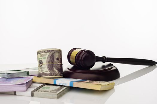 Judge's gavel and packs of dollars and euro banknotes on a white background. The concept of growing national debt- image