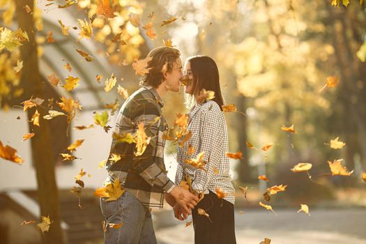 Couple in a park. Guy in a white t-shirt. Golden autumn.