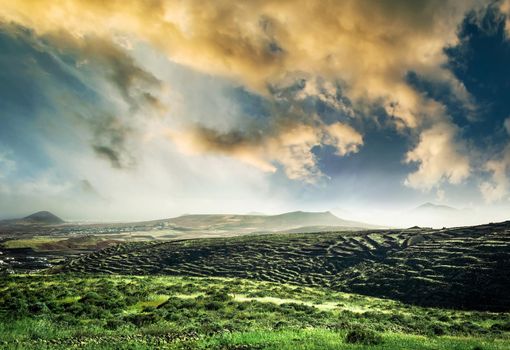 beautiful mountain landscape with green field against sunsut sky in Lanzarote, Canary Islands