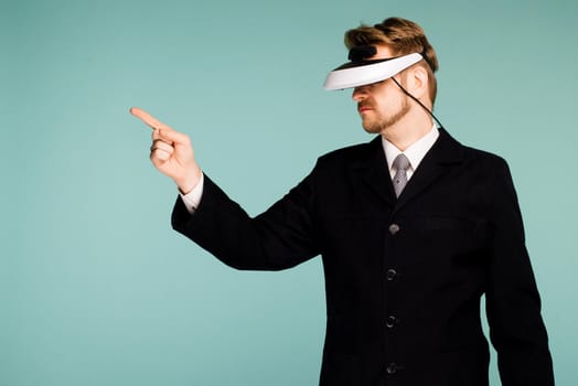 Businessman in a formal wear wearing virtual reality glasses pointing fingers away - image