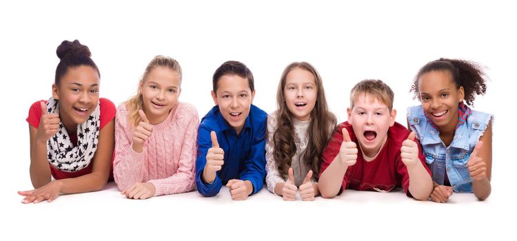 smiling children lying on the floor isolated on white backgound