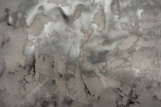 Wet black paper glued to the wall. Wet paper texture.- image