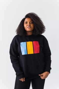 Young beautiful african american girl with an afro hairstyle. Portrait on white background. Girl looking at camera