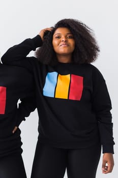 Young beautiful african american girl with an afro hairstyle. Portrait on white background. Girl looking at camera