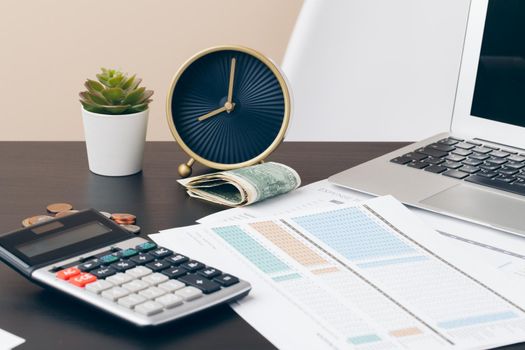 avings, finances, economy and home concept - close up of calculator counting money and making notes at home