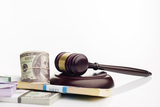 Judge's gavel and packs of dollars and euro banknotes on a white background. The concept of growing national debt- image