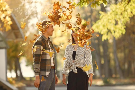 Couple in a park. Guy in a white t-shirt. Golden autumn.