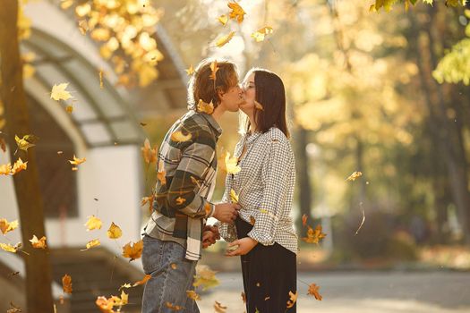 Couple in a park. Guy in a white t-shirt. Golden autumn.