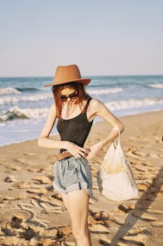 woman in trendy summer clothes by the ocean vacation sun. High quality photo