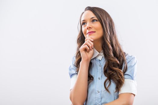 Beautiful businesswoman thinking and looking away.