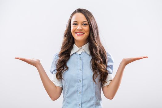 Image of beautiful businesswoman gesturing on gray background.