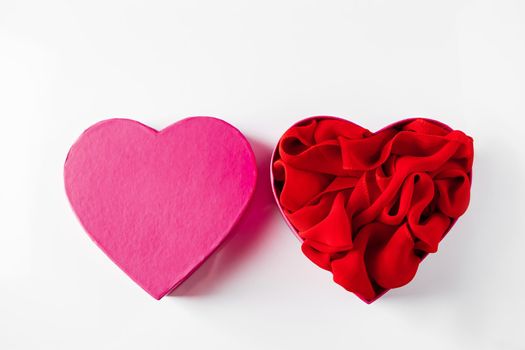 Heart shaped open gift box on white background. Concept for Valentine's Day. Open empty pink heart shaped gift box on a white background.