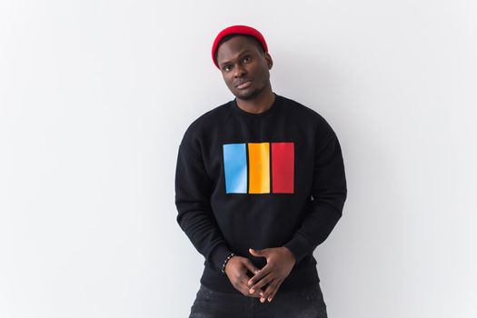 Portrait handsome young black man dressed in jeans and hoodie on white background. Street fashion and modern youth culture