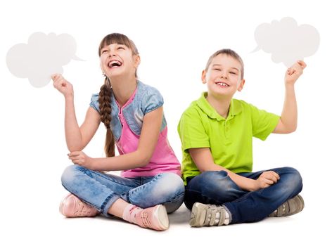 two funny children sitting on the floor with paper clouds in hands laughing isolated on white background