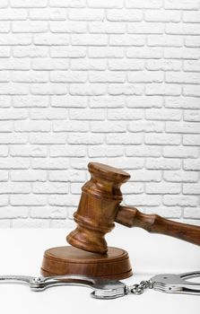 Wooden judge gavel on table, front close-up view