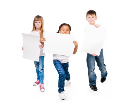 three funny children holding paper blanks in hands isolated on white background