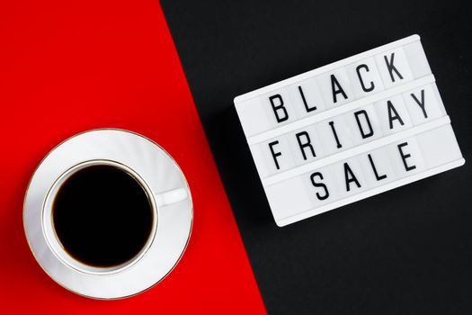 Black Friday sale concept. Cup of coffee on a red background. Banner for advertising.