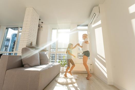 Happy loving family. Mother and her daughter child girl playing and dancing together