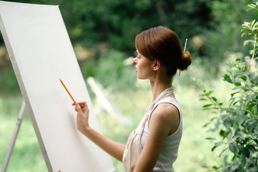 woman artist nature easel drawing creative landscape. High quality photo