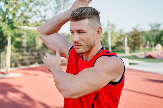 athletic man on sports ground workout exercise crossfit summer. High quality photo