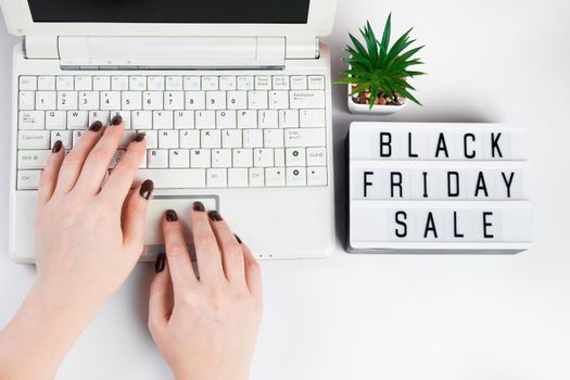 Black friday sale concept. Woman buys online using a laptop.