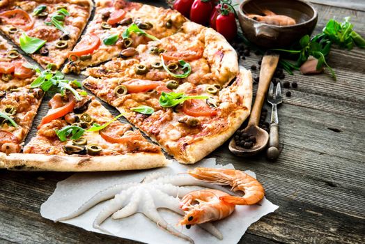 delicious pizza with seafood on wooden table