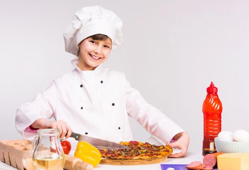 little smiling girl-cook in uniform with big pizza in hands