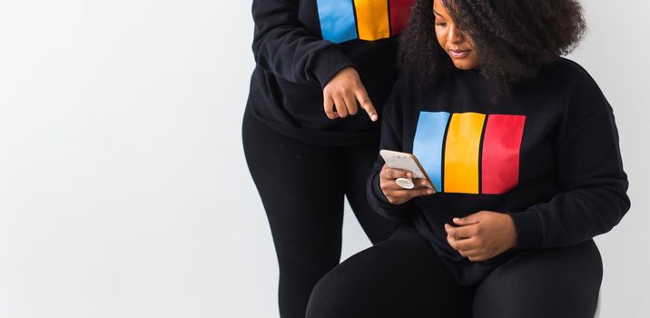 Modern Technology Concept. African american woman showing blank phone screen, mockup, selective focus