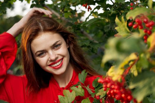 beautiful woman bush with berries nature fresh air. High quality photo