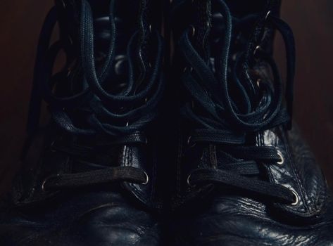 Black leather boots with shoelaces, close-up