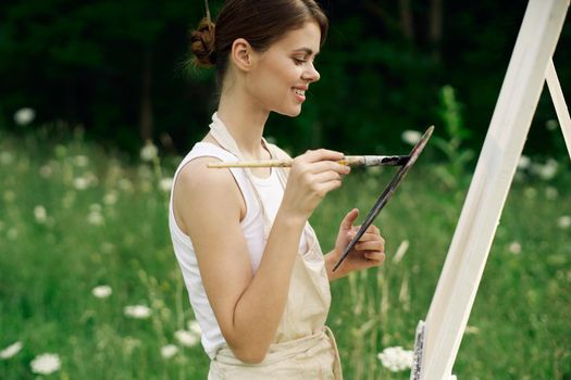 woman outdoors paint a picture landscape hobby creative. High quality photo