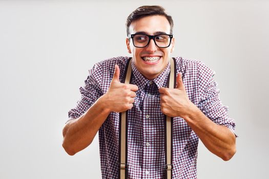 Portrait of nerdy man showing thumbs up.