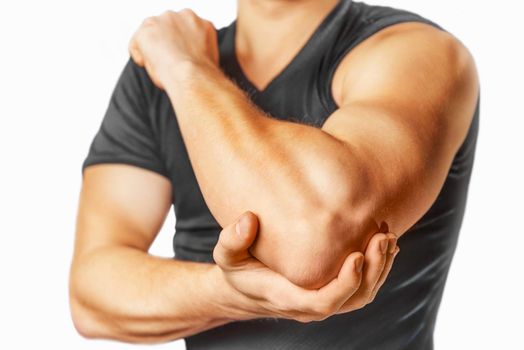 Man holds his the elbow joint, acute pain in the elbow.