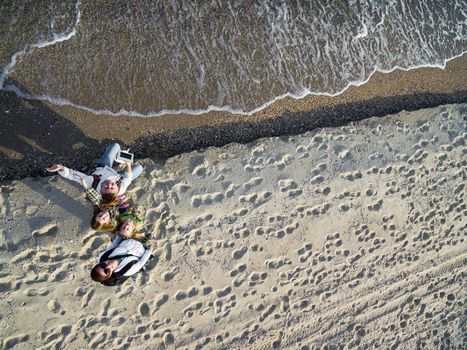 happy family walking on the beach, top view, aerial photo