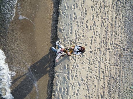 happy family walking on the beach, top view, aerial photo