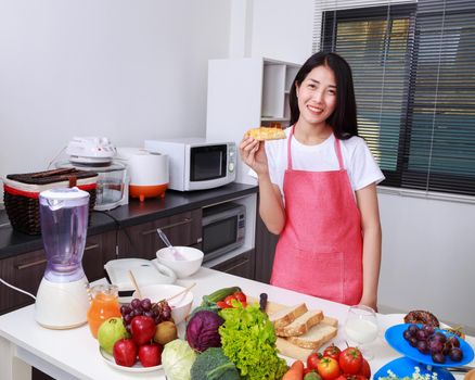 woman holding a bread in kichen room at home