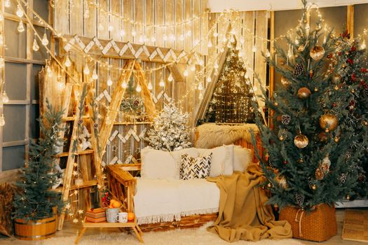 Home Christmas interior, with a Christmas tree and lots of glowing garlands and light bulbs. Preparing for the Christmas party at home.