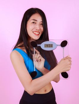 happy slim woman holding a weight scale