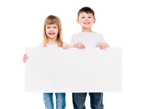 little cute boy and girl holding an empty paper sheet isolated on white background