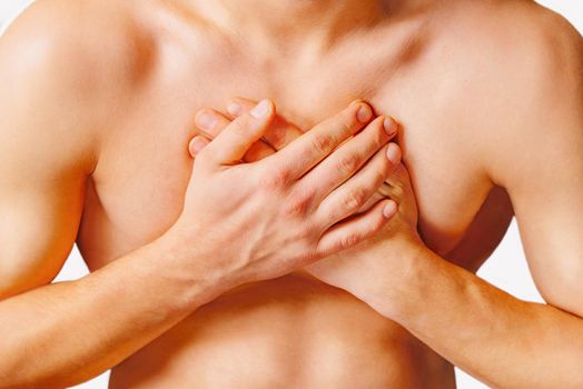 Man is clutching his chest, acute pain possible heart attack. On a white background
