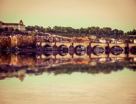 beautiful view of the Charles Bridge and other sights with reflection in Prague, Czech Republic