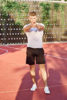 man in white t-shirt on the sports ground workout motivation. High quality photo