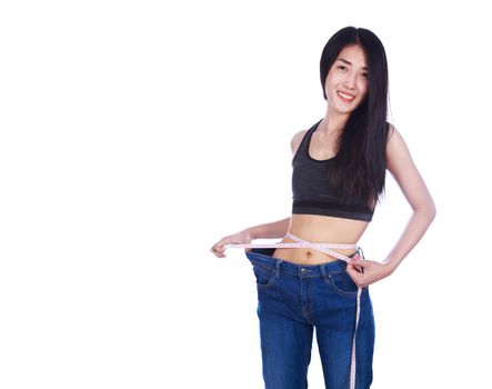 weight loss woman wearing her old jeans and measure tape isolated on a white background