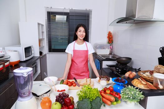 young beautiful woman cooking in kitchen room at home