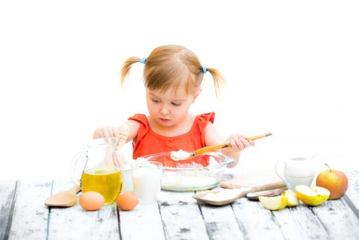 cute little baby girl baking on a white background